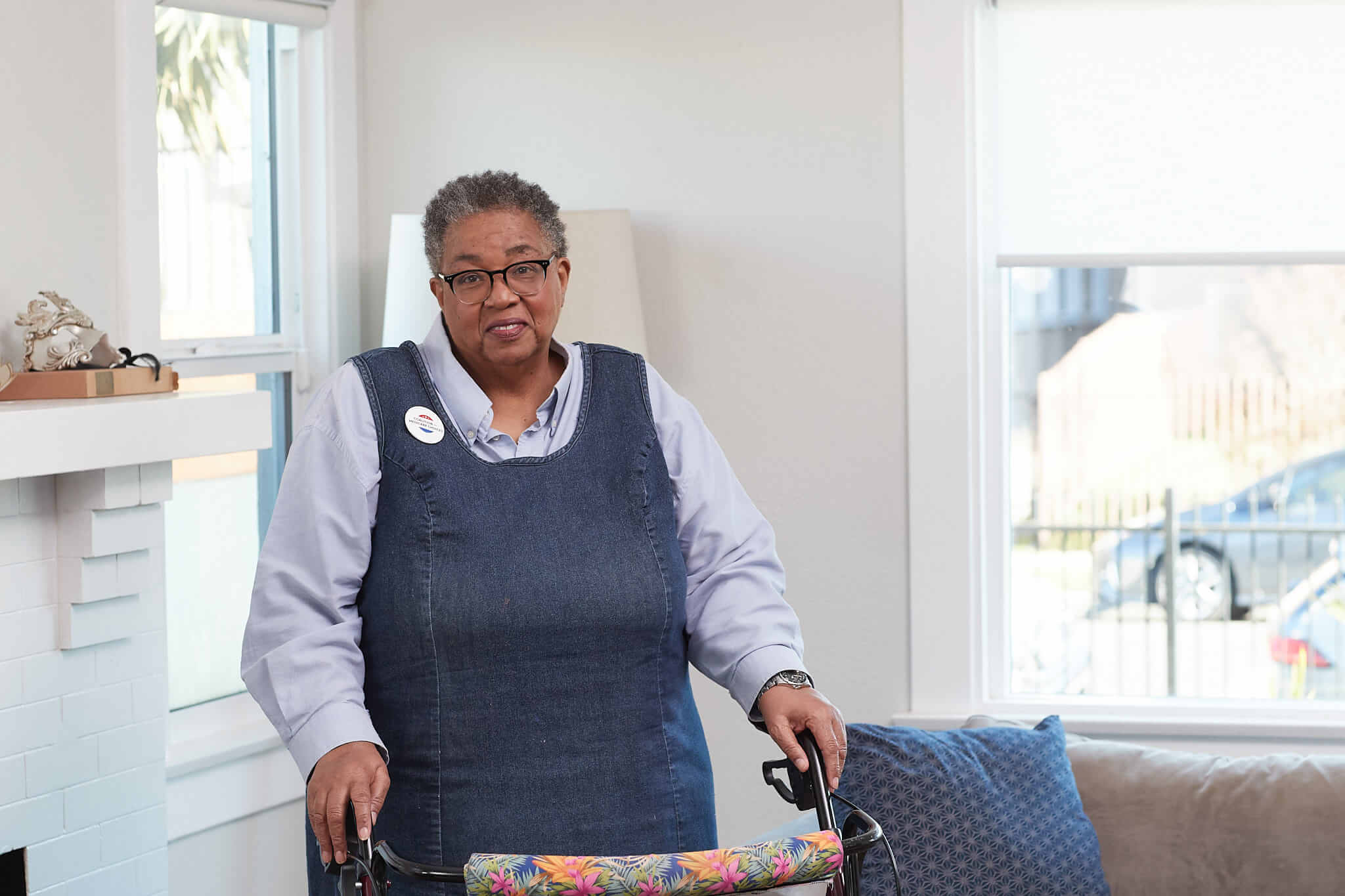 A Medicare Advantage–enrolled senior posing with her assistive walker