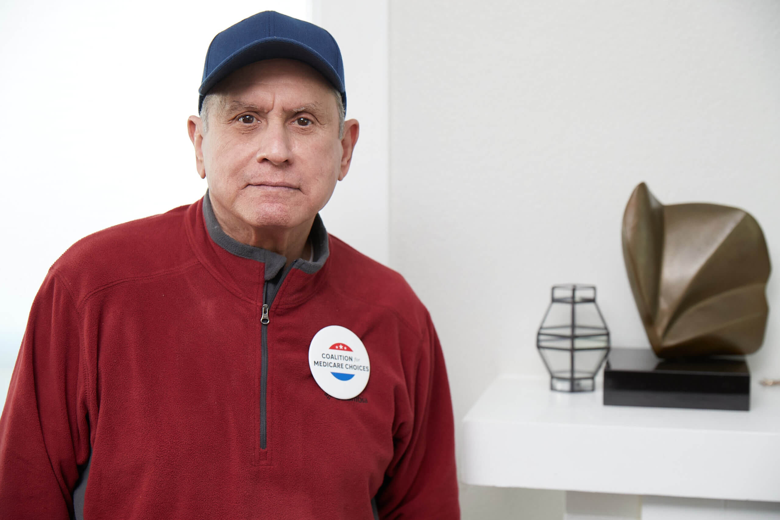 A Medicare Advantage–enrolled senior posing in his home