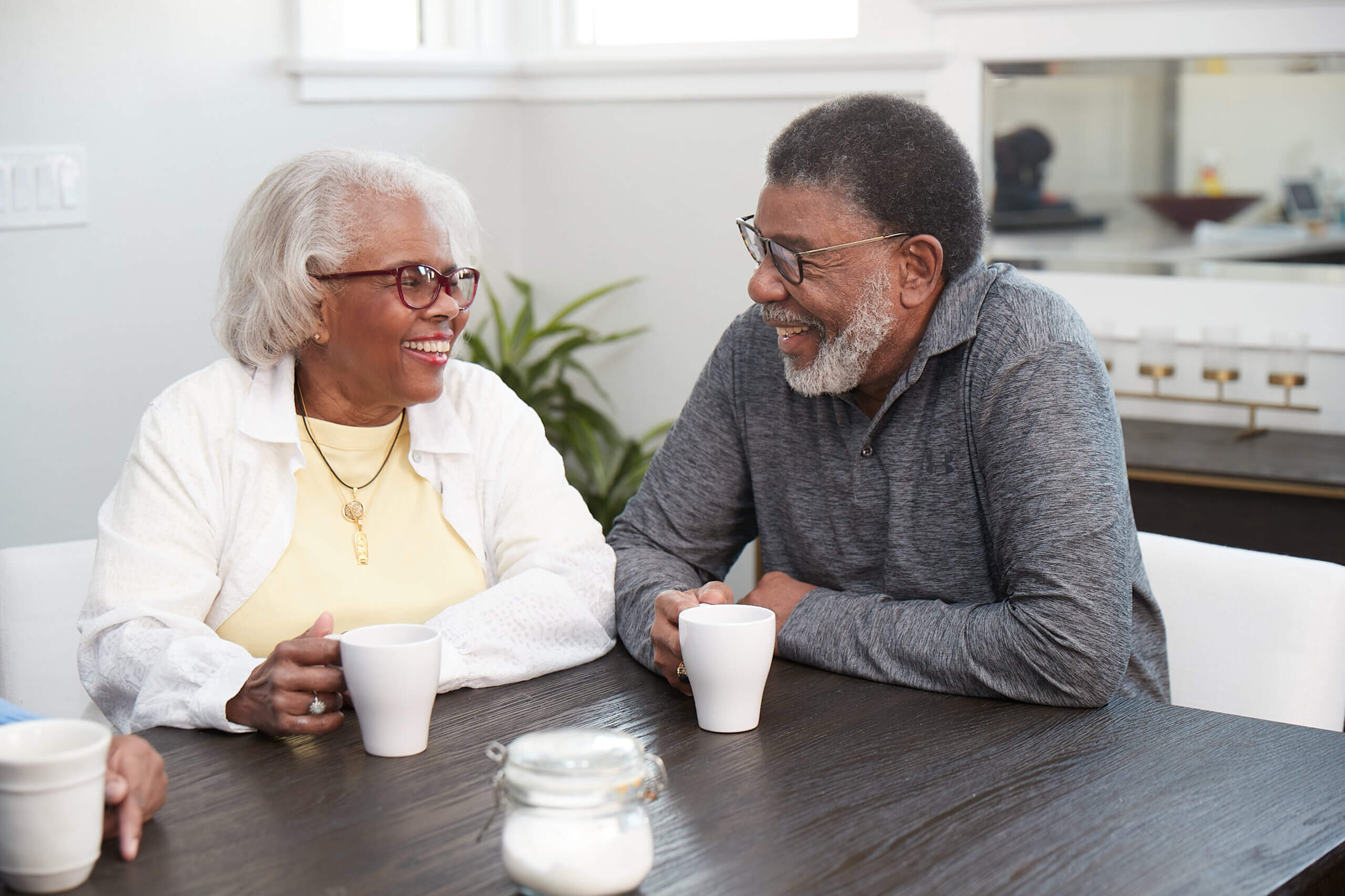 Medicare Advantage–enrolled seniors laughing with their morning coffee
