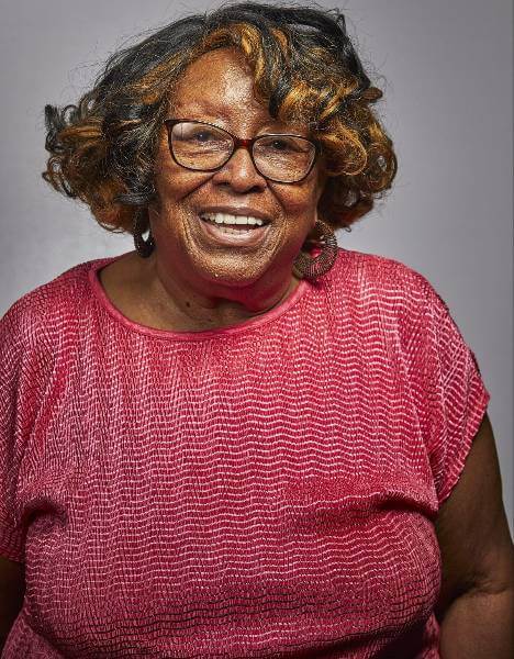 A Medicare Advantage–enrolled senior posing happily while sharing her story