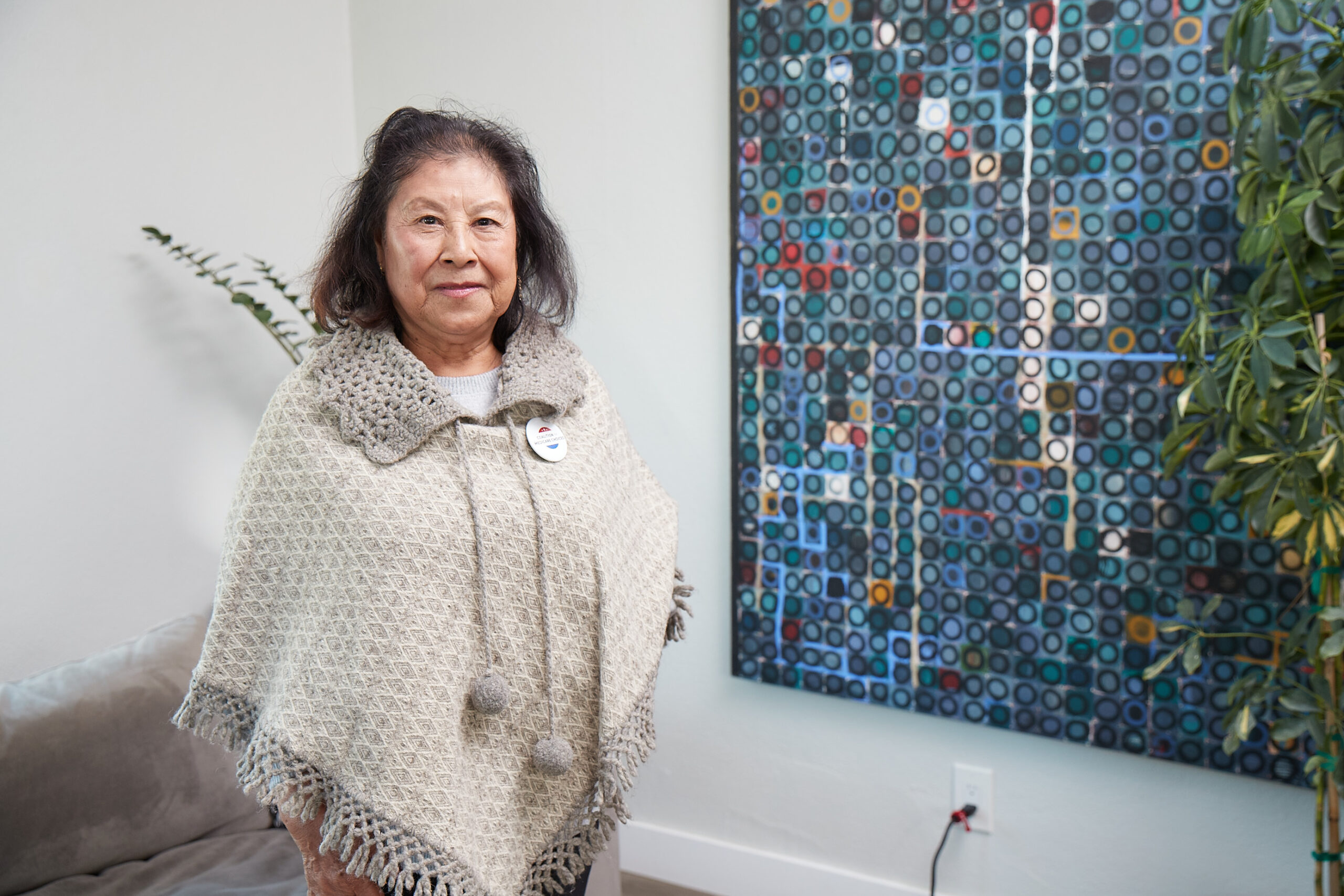 A Medicare Advantage–enrolled senior posing by a work of art
