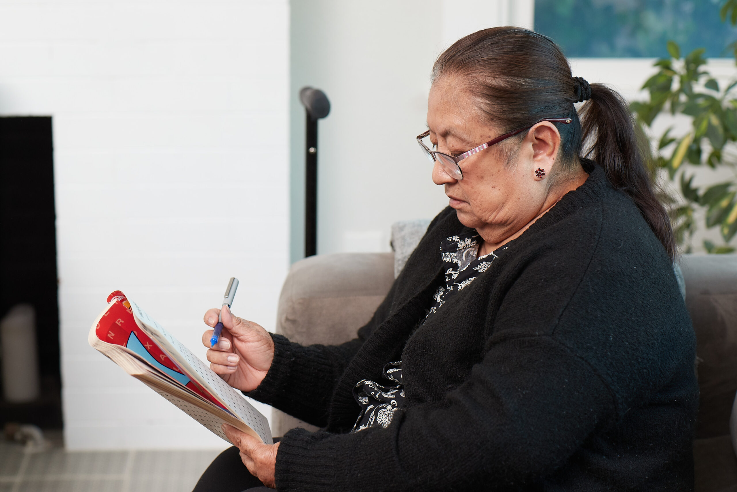 A Medicare Advantage–enrolled senior working on a word search puzzle